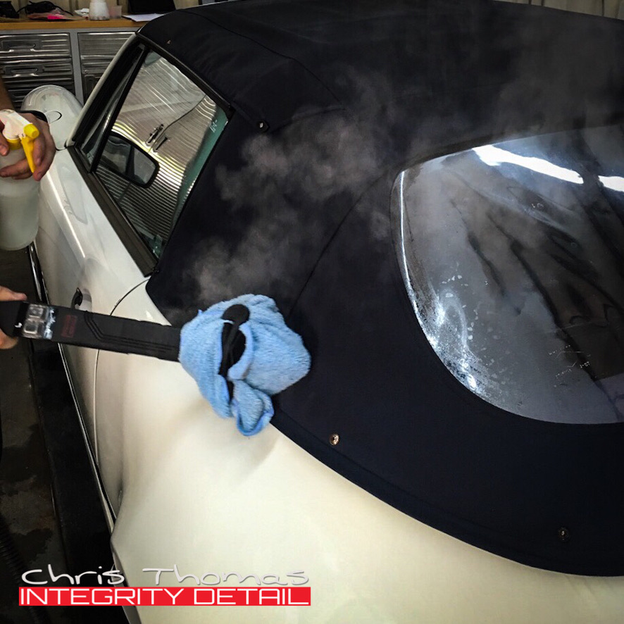 Steam cleaning a dark fabric convertible top at Integrity Detail