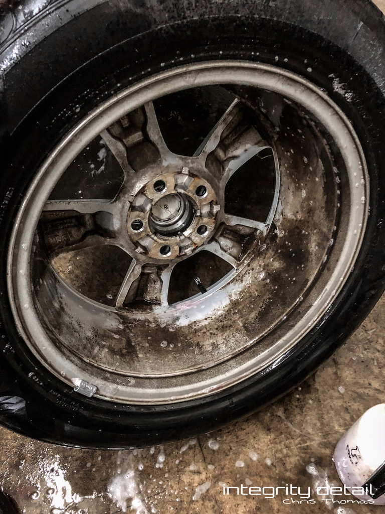 Removed wheel with brake dust and grime on its inner barrel before cleaning