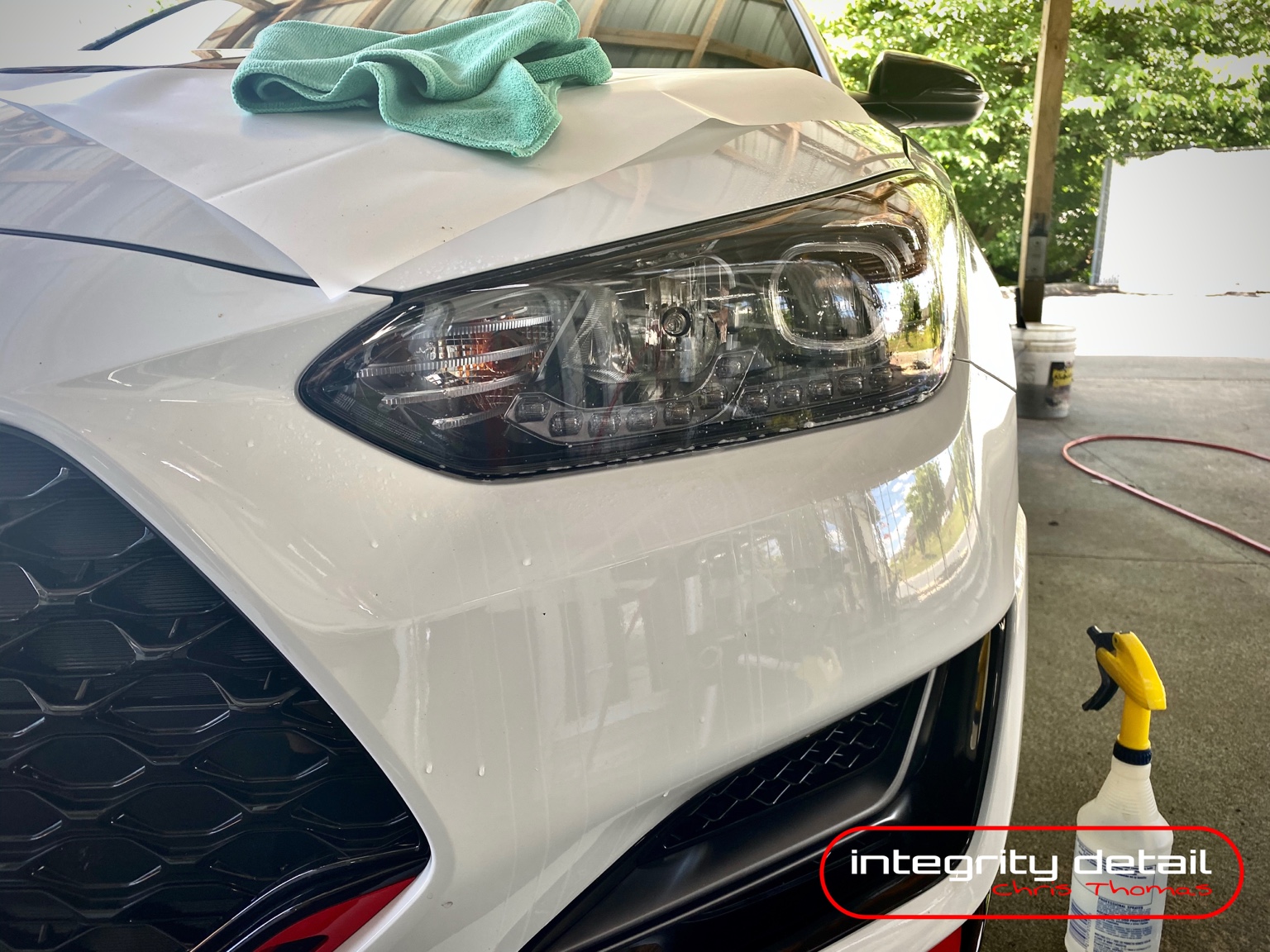 Untinted headlight on a white Hyundai before dark protective film installation