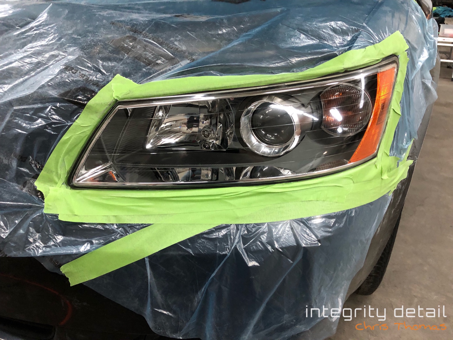 After Integrity Detail headlight restoration: the same lens restored to clarity, with the reflector and projector clearly visible