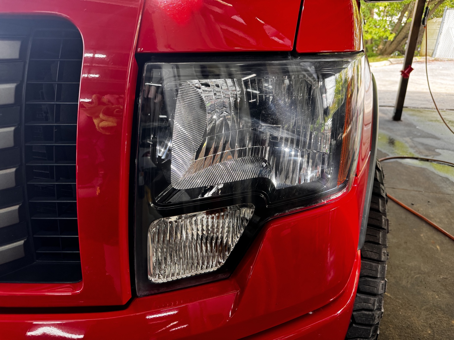 Untinted headlight on a red truck