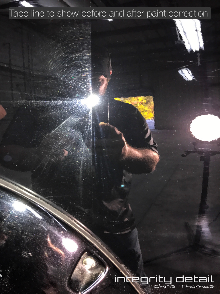 Actual Integrity Detail paint correction comparison across a tape line: swirl marks on the left and clearer polished black paint on the right