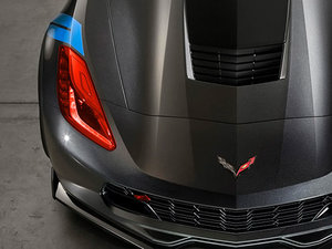 Front view of a black Corvette with a blue film sample near the headlight