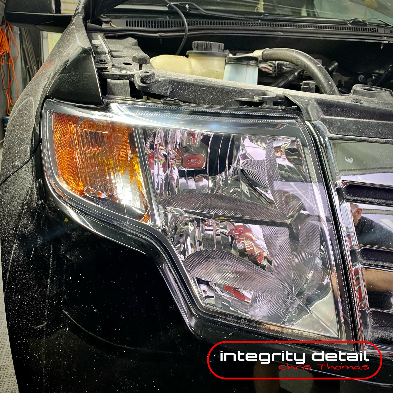 Clear restored truck headlight with Integrity Detail watermark