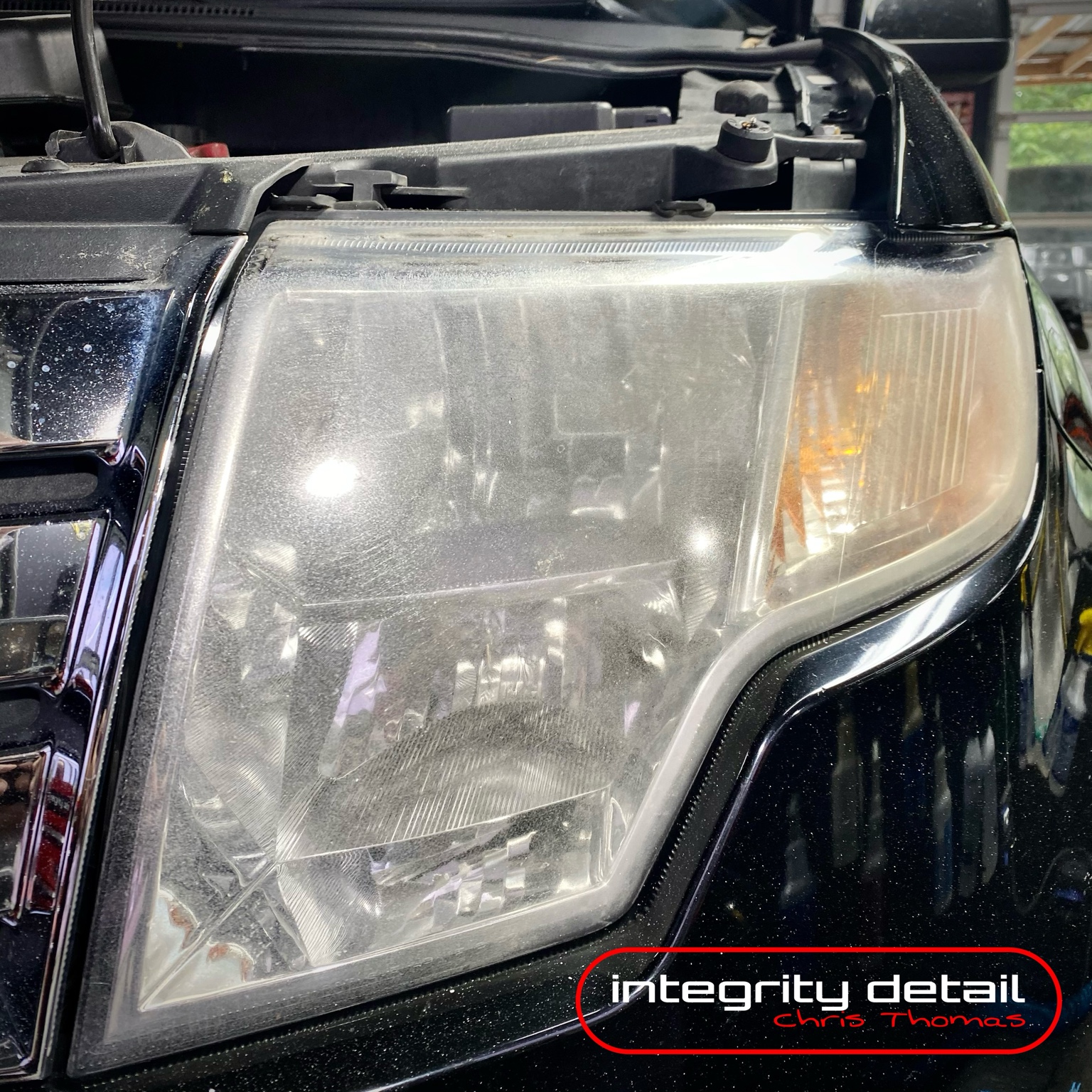 Cloudy unrestored truck headlight with Integrity Detail watermark